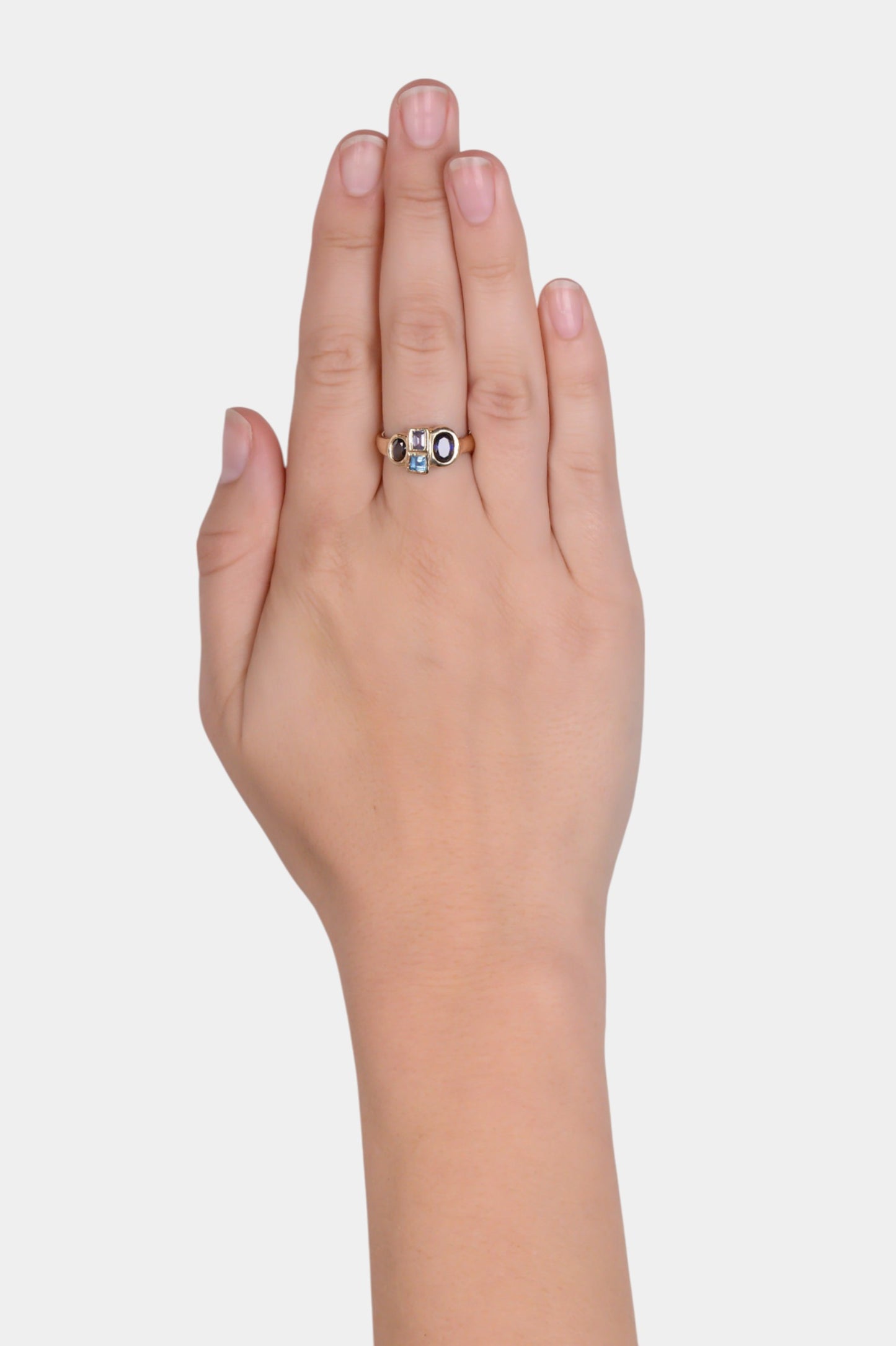 McCrae Ring wearing on hand
~ 5x3.5mm oval cut blue sapphire
~ 3x4mm emerald cut blue sapphire
~ 3mm square cut blue topaz
~ 6.5x4.5mm oval cut blue sapphire