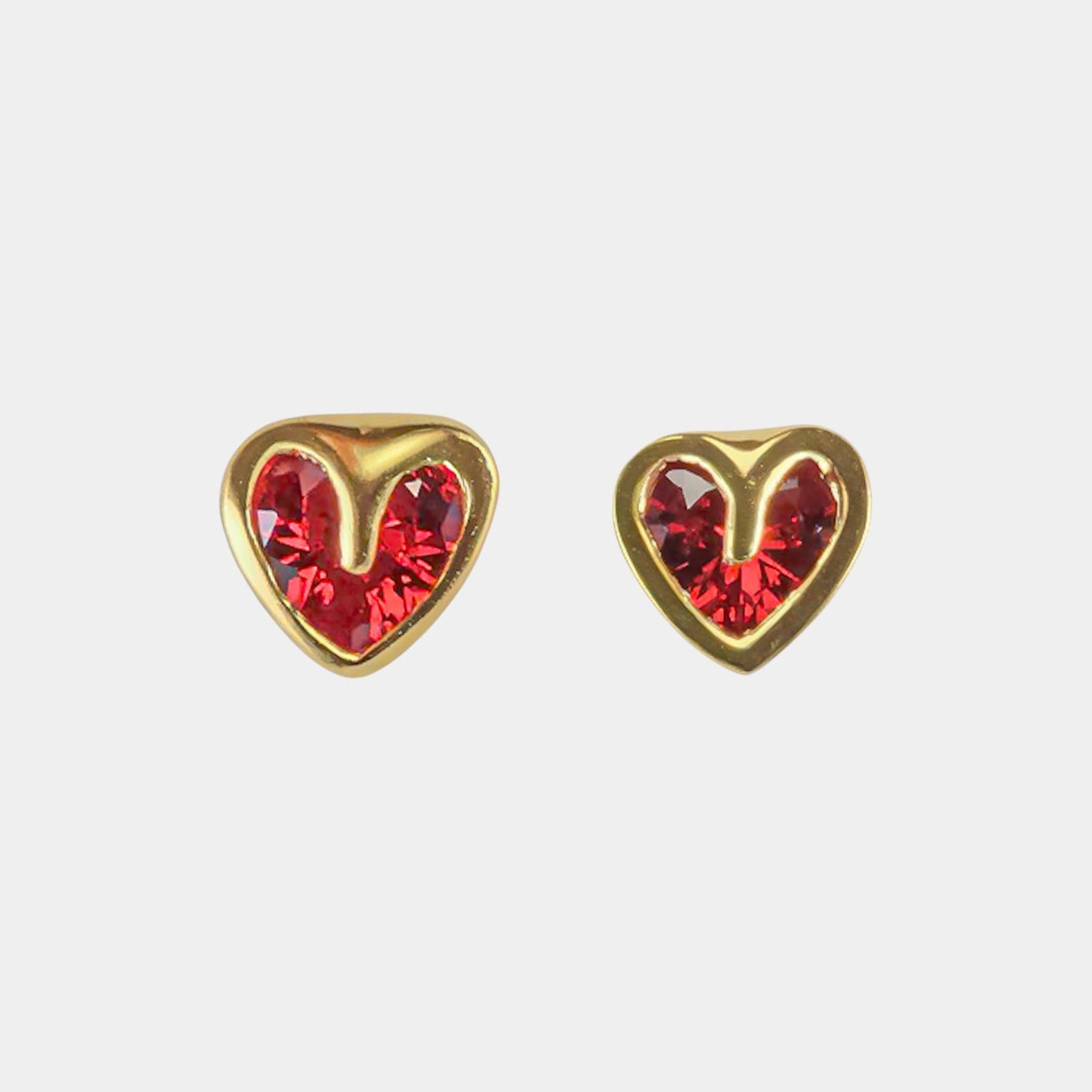 Heart-shaped earrings with red gemstones on a white background