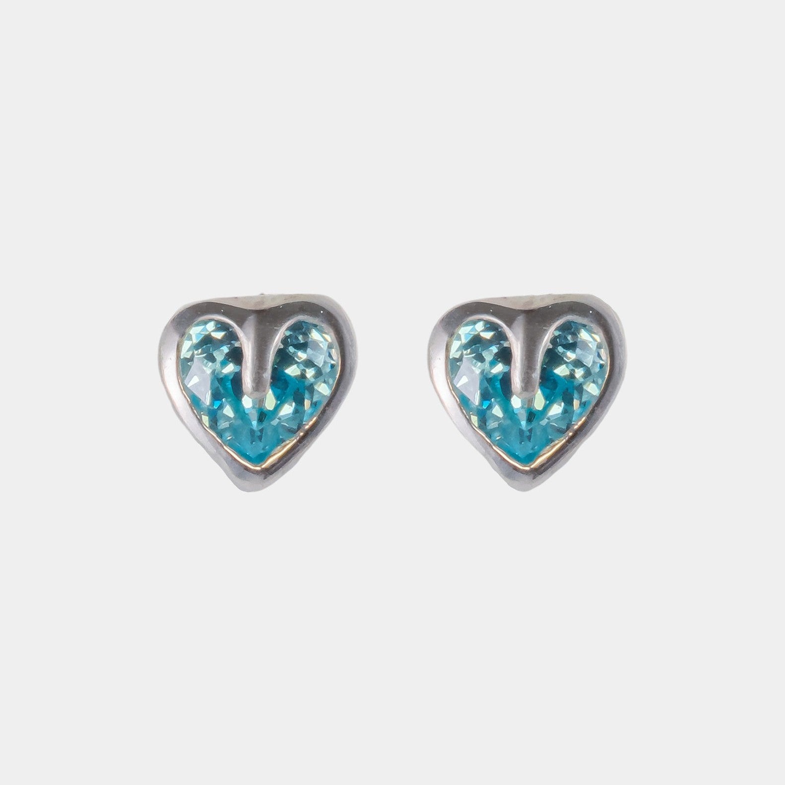 Heart-shaped earrings with blue and silver design on a light gray background