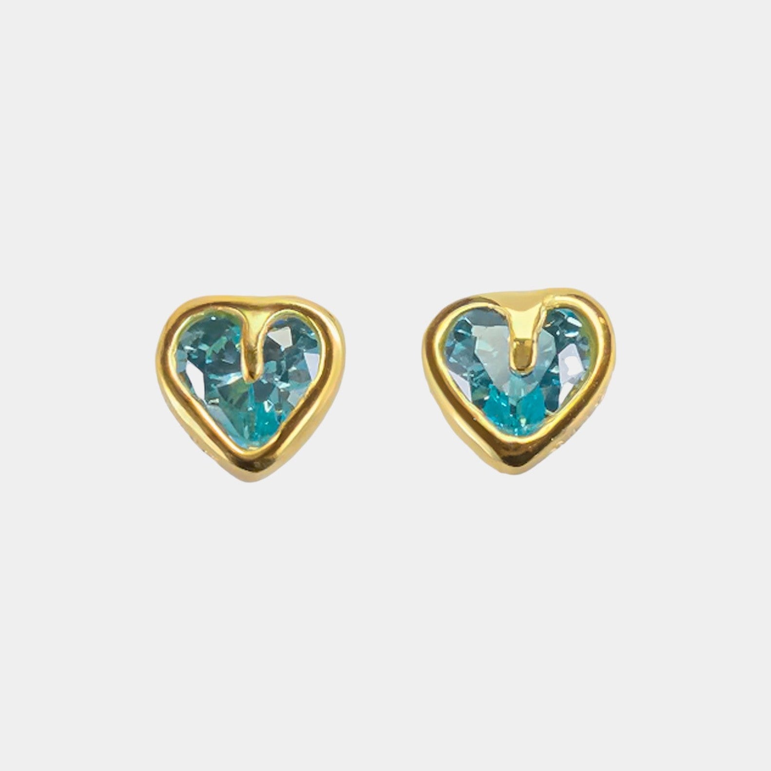 Heart-shaped earrings with blue gemstones on a white background