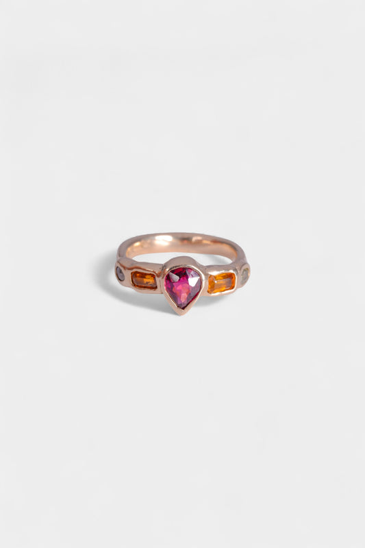 Amie Ring
~ two oval cut fancy yellow natural melee diamonds
~ two 3x5mm emerald cut orange sapphires
~ 7.5x6mm pear cut rhodolite garnet