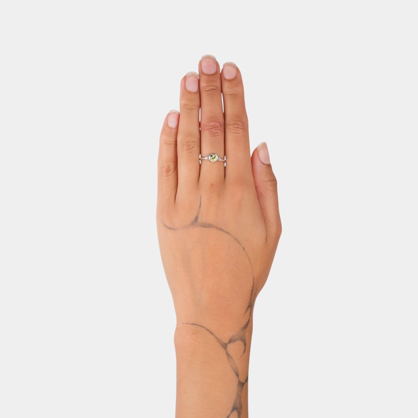 Hand with a ring on a plain background