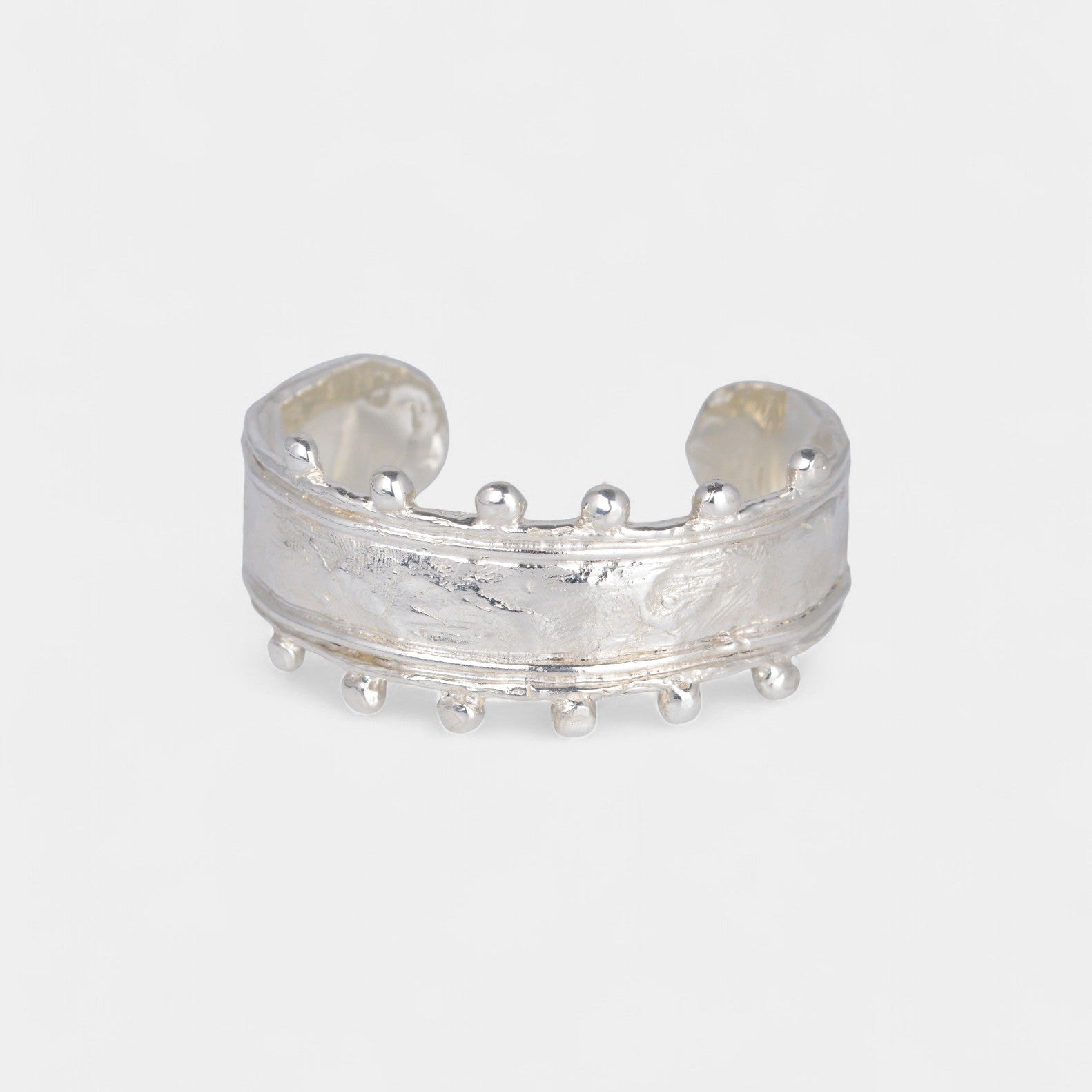 Silver open cuff bracelet on a white background