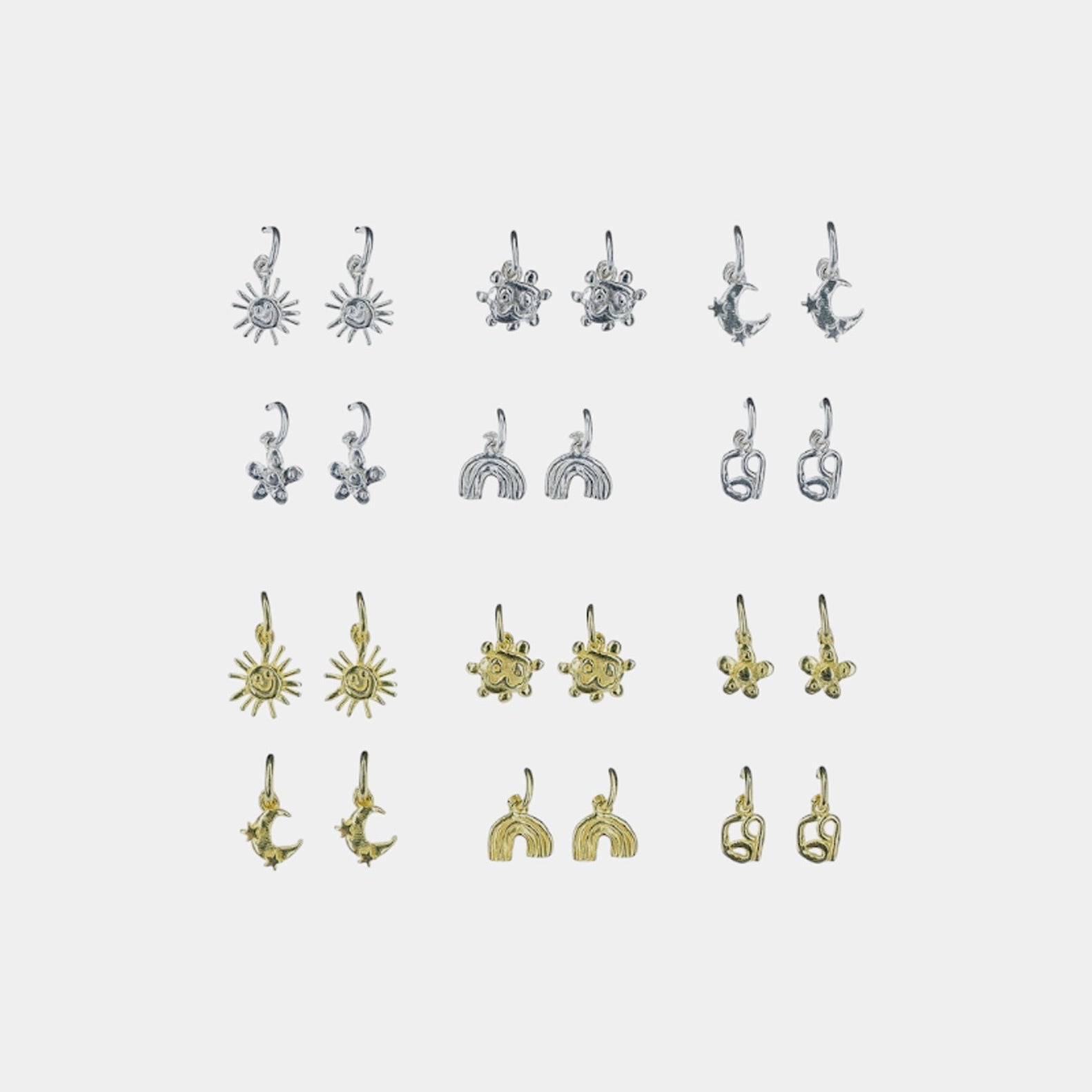 A collection of charm hoop stud earrings displayed in rows, with charms in various designs attached to them. The earrings are presented in silver and gold colors.