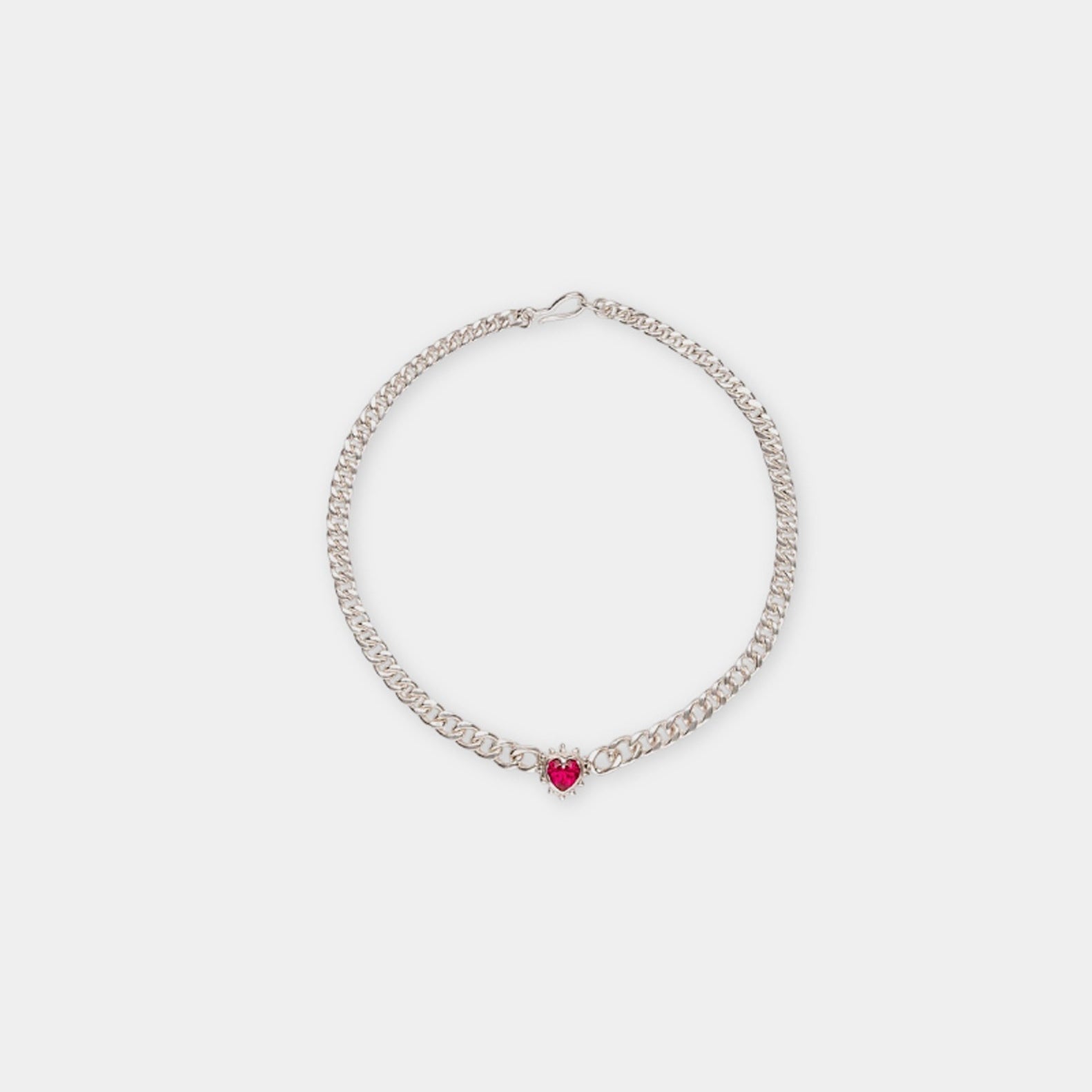A silver necklace with a red nano ruby heart pendant and a hand-made taped chain.