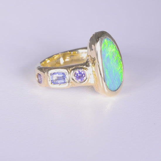 Mills Ring 
~ four 3mm round pink sapphires
~ two 3x5mm emerald cut blue sapphires
~ 14x7mm Aussie opal doublet