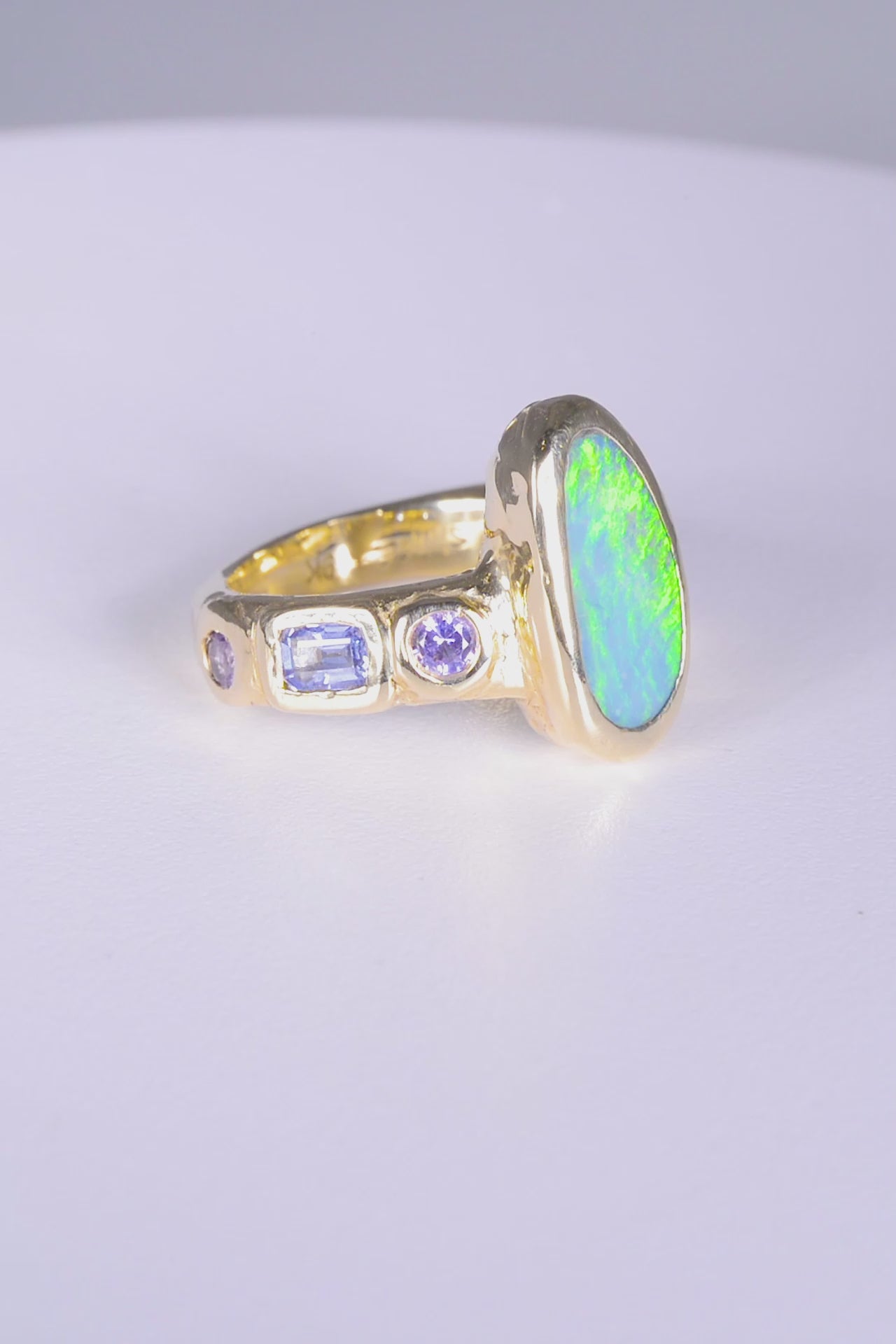 Mills Ring 
~ four 3mm round pink sapphires
~ two 3x5mm emerald cut blue sapphires
~ 14x7mm Aussie opal doublet
